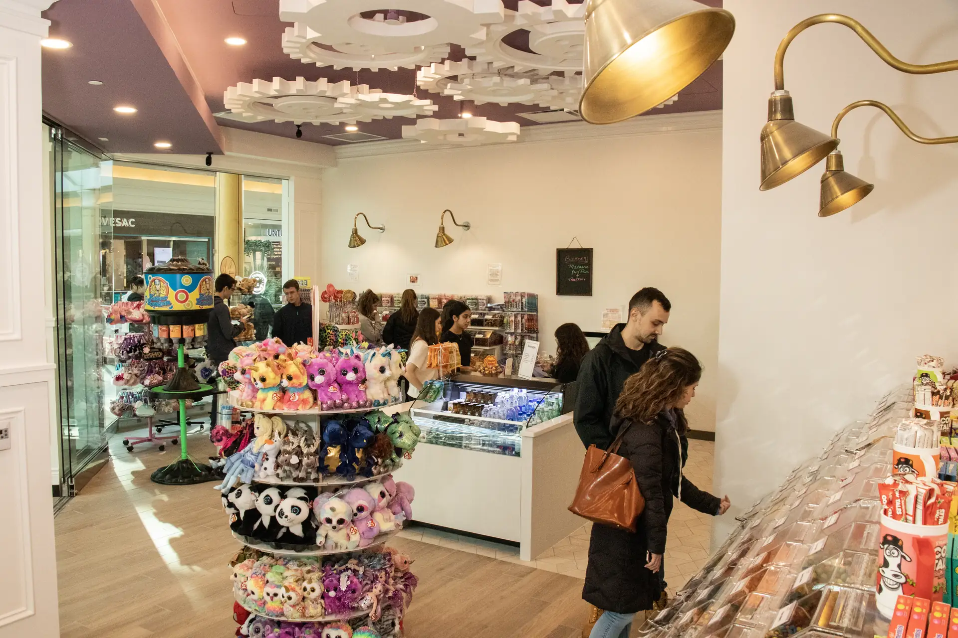 Busy Sweet Factory store interior showing gear-themed ceiling at Somerset Mall